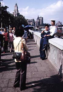 woman photographing sailors in shanghai