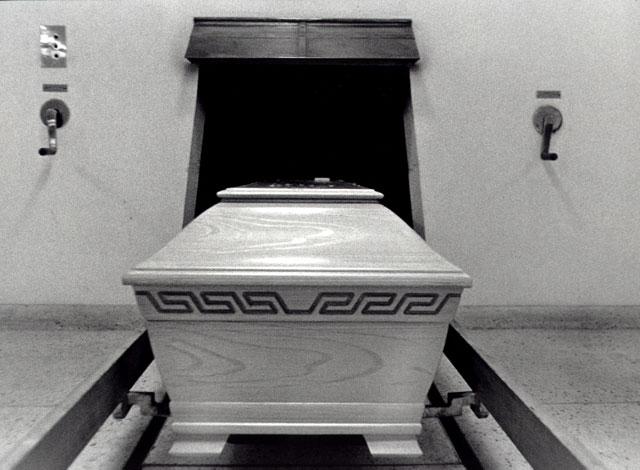 coffin in front of the door to the incinerator
