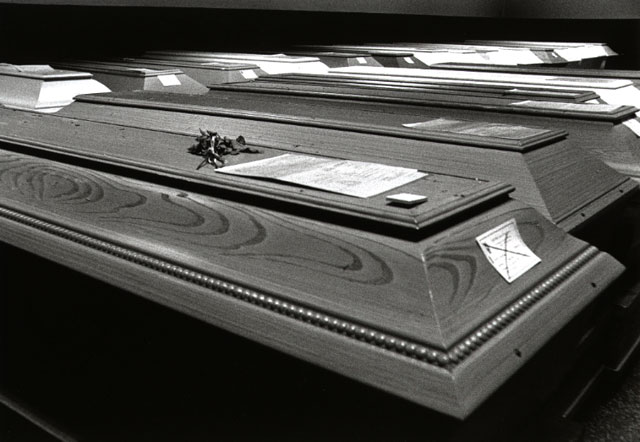 coffins waiting in rows to be cremated