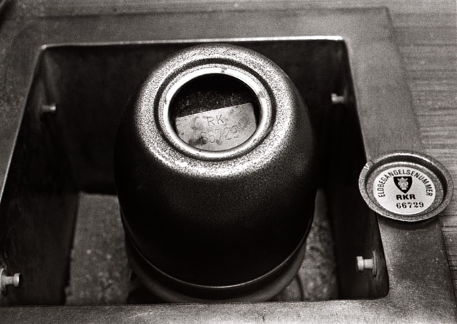 Ashes and the fire proof plate inside the urn