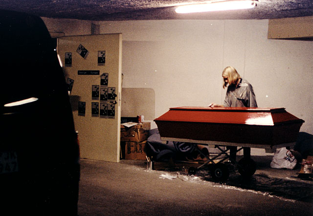 Granddaughter painting grandmother´s coffin red