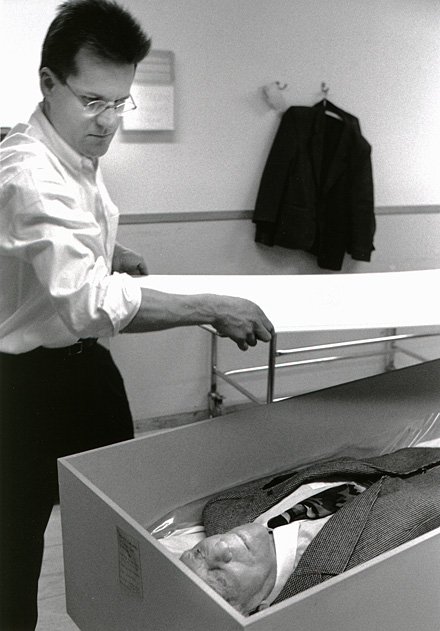 dead father shrouded in his own clothes, the lid of the coffin is put over