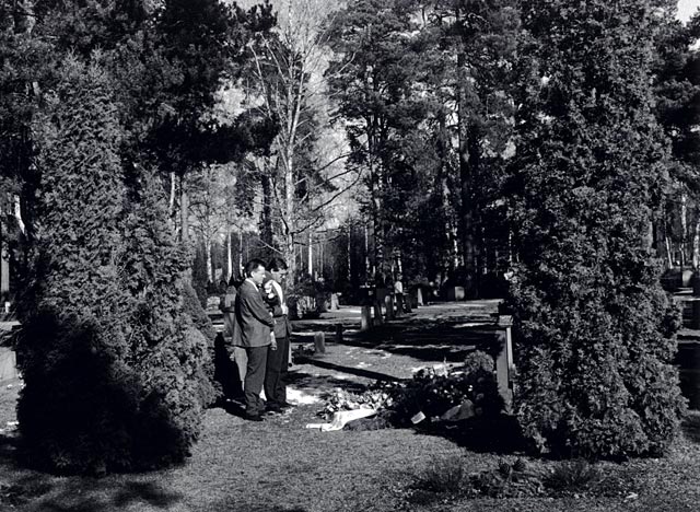 Relatives standing by the tomb