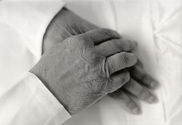 Hands of a dead person, open casket