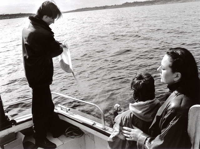 a son scattering the ashes of his mother to the winds