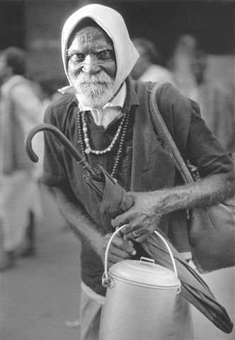 old man umbrella beard hairy arms intense eyes