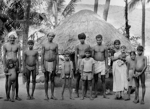 family portrait of farmers standing on their home yard in Kudle India 1987