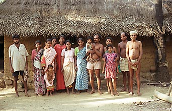 family portrait of farmers standing on their home yard in Kudle India, 1999