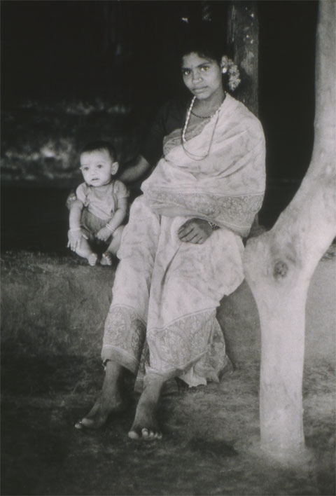 Peasant´s wife with young child sitting on the porch