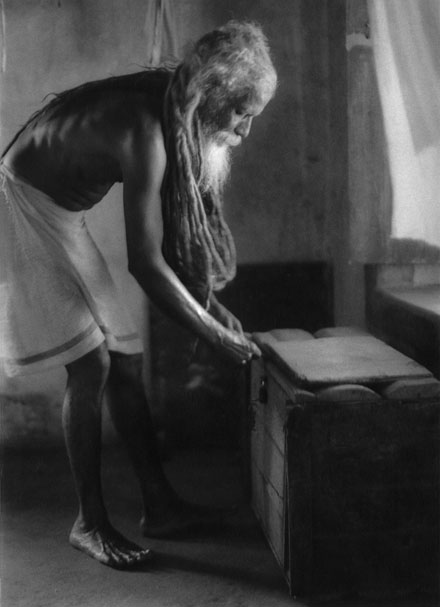 Sadhu India Gokarna Hanuman temple reaching his trunk Soft light from windows