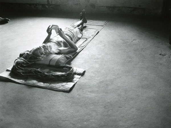 Sadhu reading a book Long hair placed on a mat Backlight