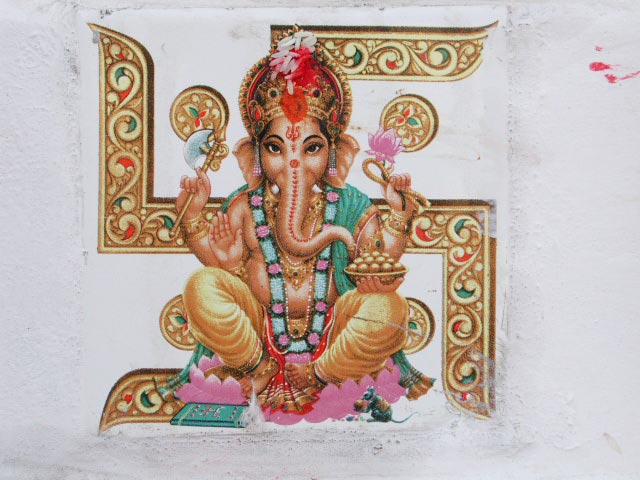 The god Ganesh depicted with the Swastika in the background
