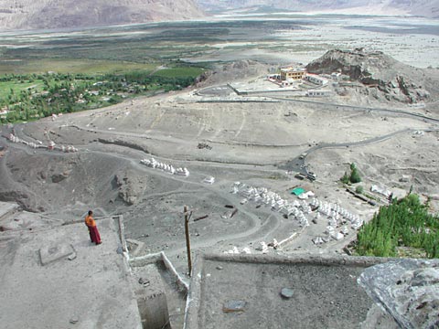 Tibetan monk viewin over Himalay from monastery