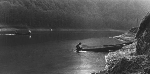 Man in a boat in Nepal, Himalayans