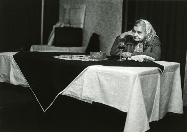 woman by table and glass of wine