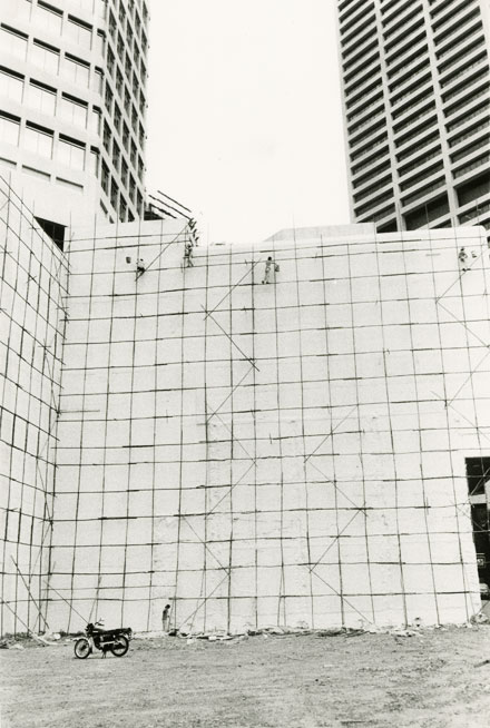 men working on bamboo scaffolds on a sky scraper Singapore 1982