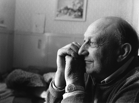 Man with his hands in front of his face looking peacefully, nice light coming from a window