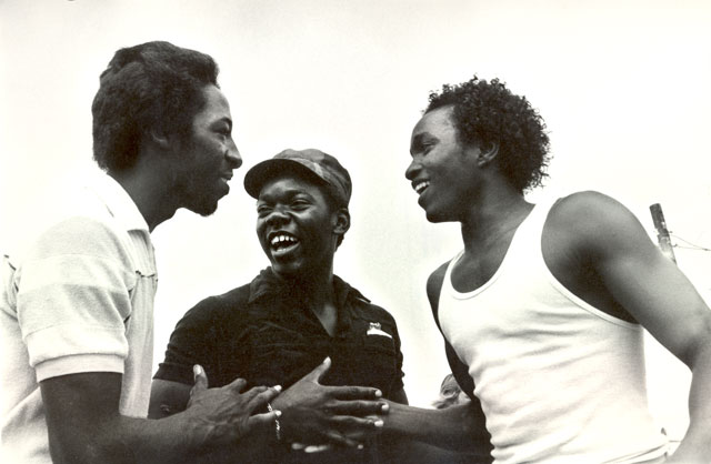 three black guys laughing clapping shaking hands. great friendship unity and joy of human relationship