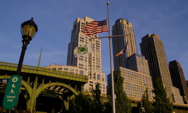 American flag and sky scrapers in the background