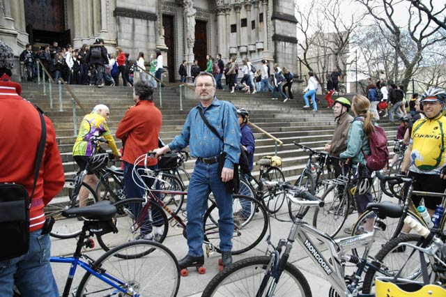 Bicycles and a rollerskater gathered outside the church. Blessing of the Bikes at The Cathedral Church of St. John the Divine