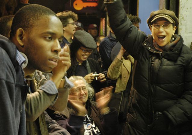 democrats cheering on the Upper west side when Obama was announced as the winner as the president. Black man watching the news on tv with surprise