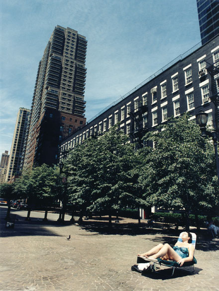 New york, woman sun bathing alone with sky skrapers in the background, Upper East Side