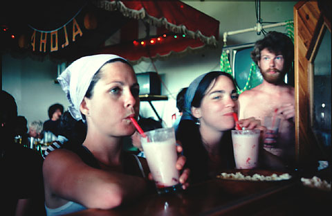 side wald slammer mirror image two women drinking with straw